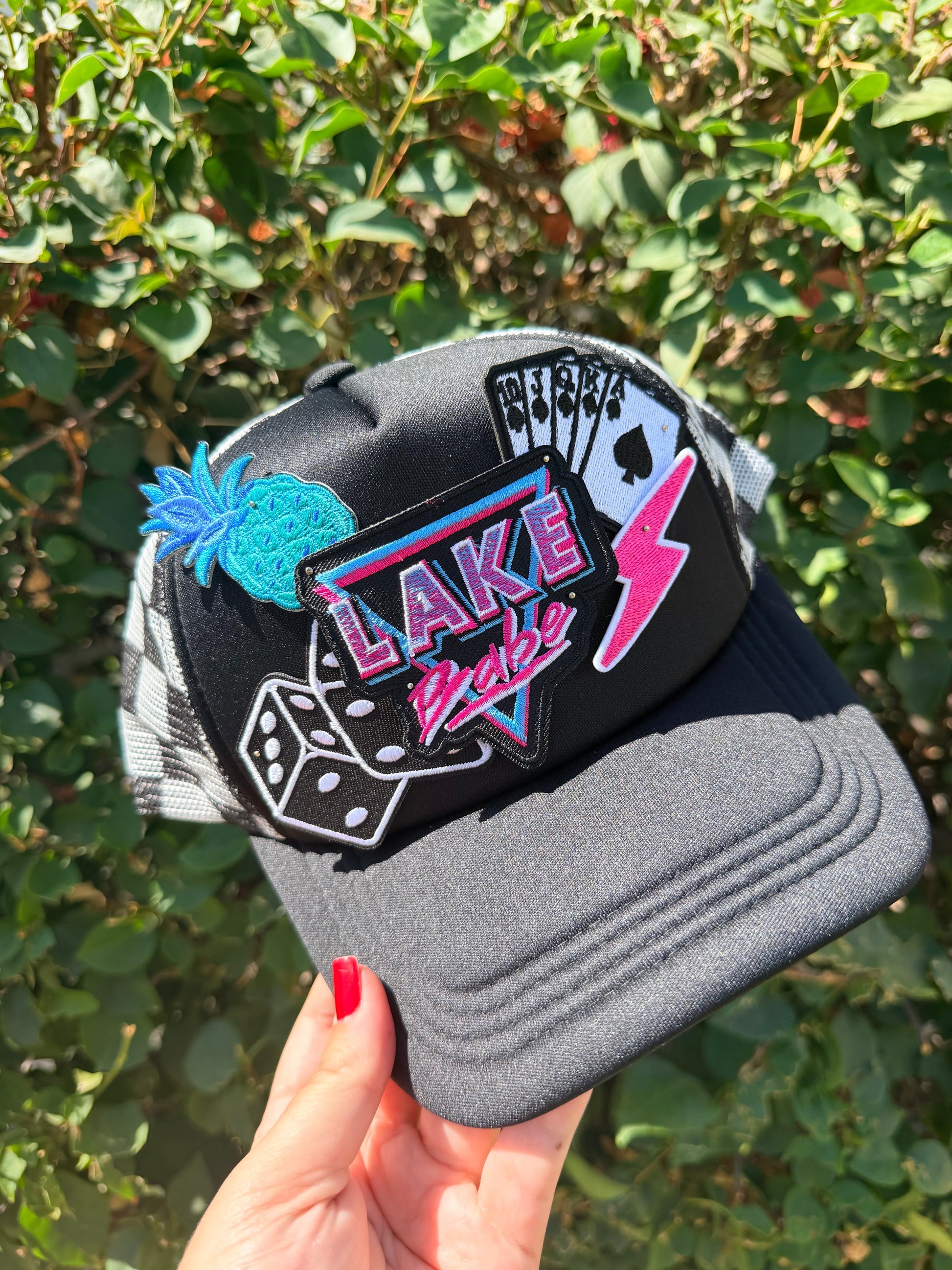 High Desert Hats Lake Babe Patch Trucker Hat with embroidered lake scene and adjustable mesh back.