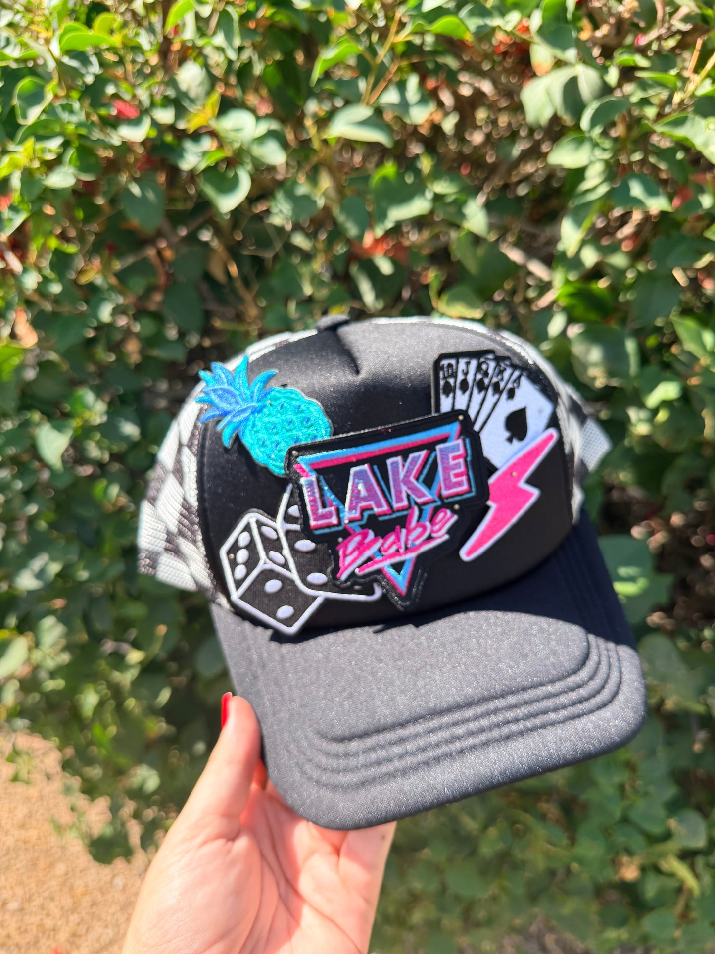 High Desert Hats Lake Babe Patch Trucker Hat featuring a colorful embroidered patch and structured mesh back for casual style.