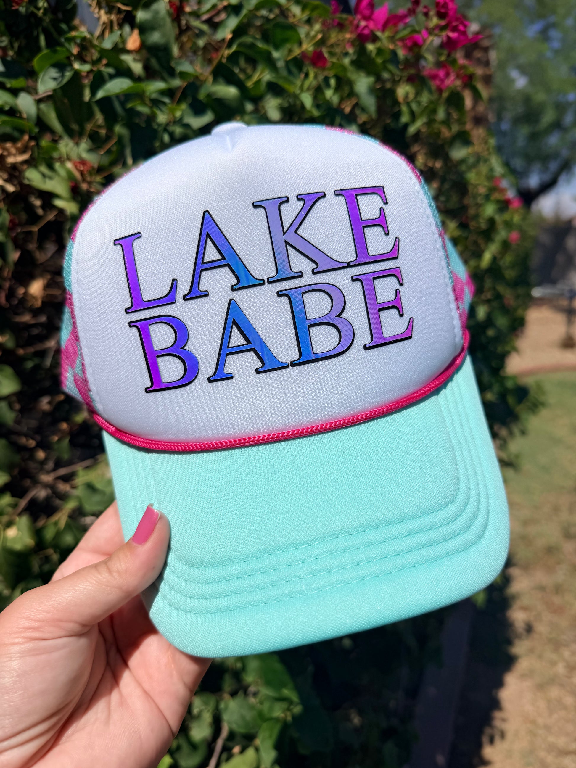 High Desert Hats Lake Babe Trucker Hat featuring a mesh back and embroidered lake design on the front.