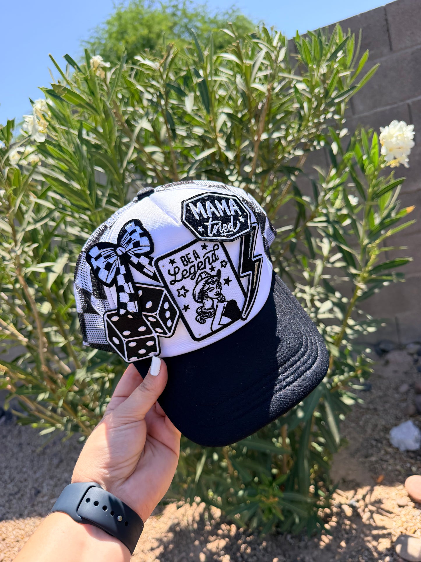 High Desert Hats Mama Tried Be A Legend checker patch trucker hat with adjustable snapback and embroidered design.