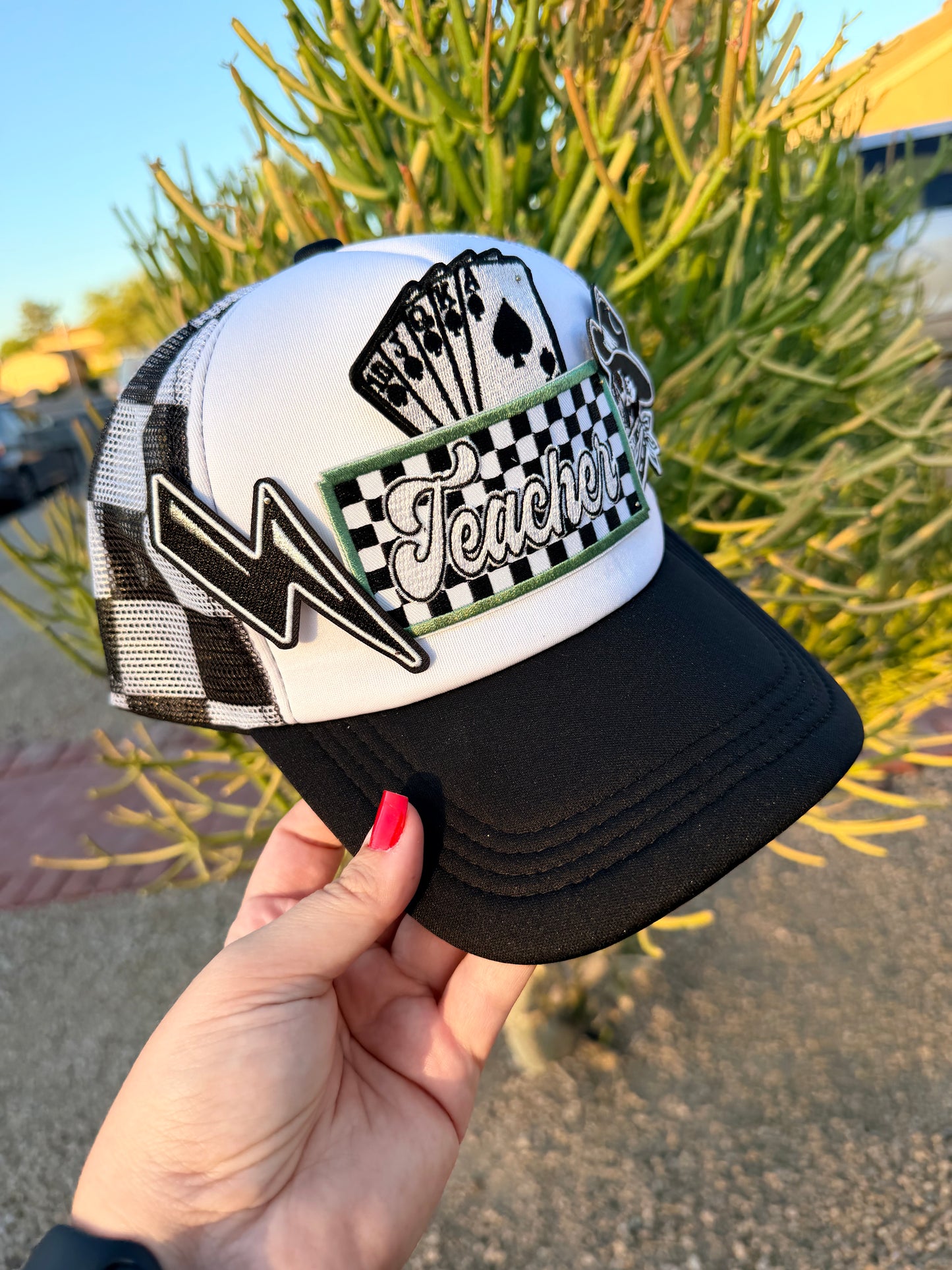 High Desert Hats Teacher Outlaw premade trucker hat featuring a stylish design with mesh back and adjustable snap closure.