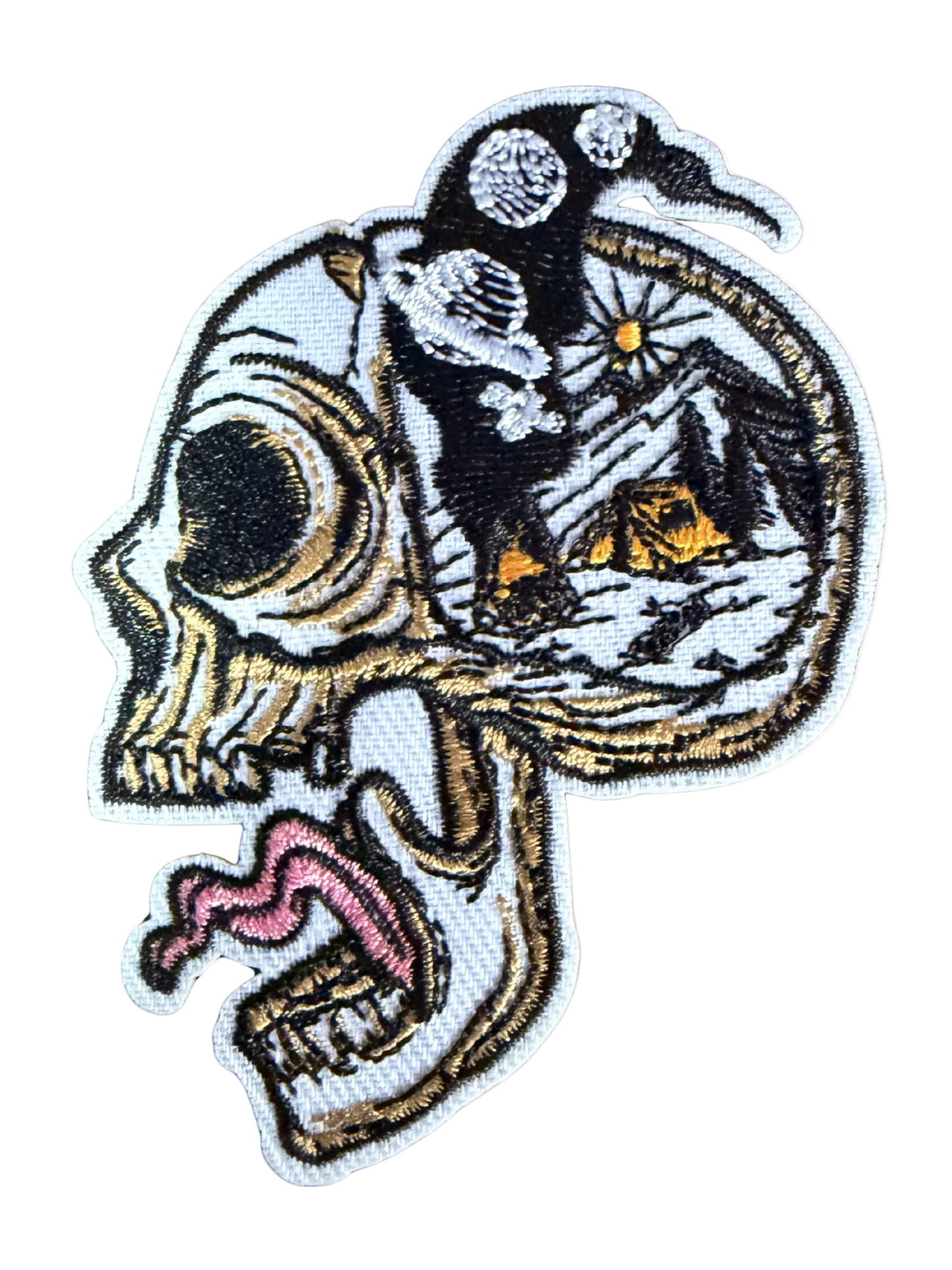 Skull side profile with open cranium showing mountain camping scene under starry night sky patch