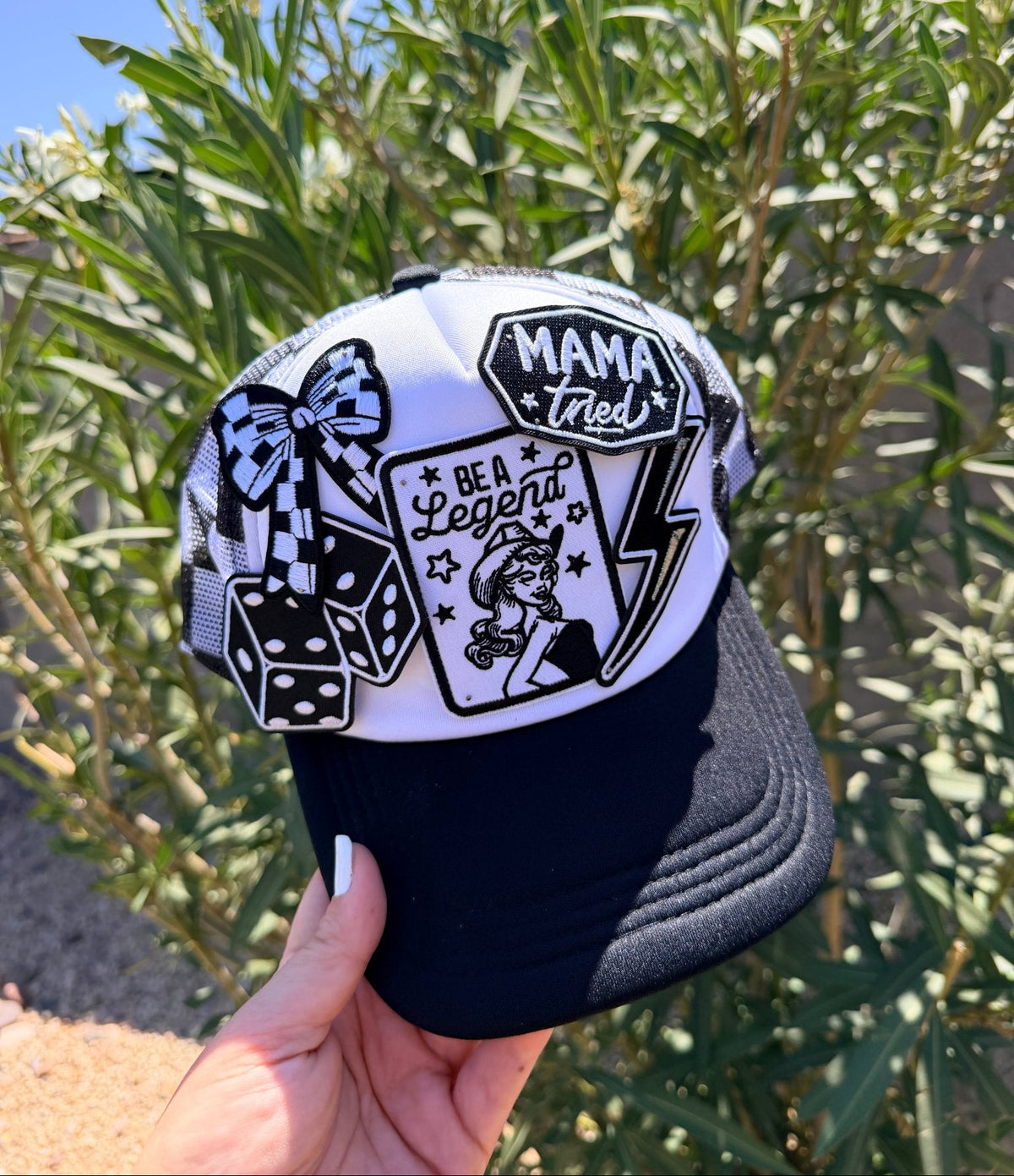 High Desert Hats Mama Tried Be A Legend checker patch trucker hat in black and white, western style with snapback closure.